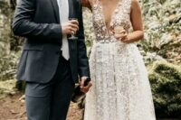 08 a gorgeous lace applique midi wedding dress with a plunging neckline and no sleeves plus nude shoes