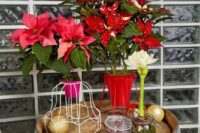 09 a barrel wedding prop with lampshade wires and bold poinsettias, some jars with candles and ornaments is cool
