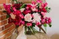 09 a bold fuchsia and blush wedding bouquet with much dimension and texture and blush ribbons for a Valentine wedding