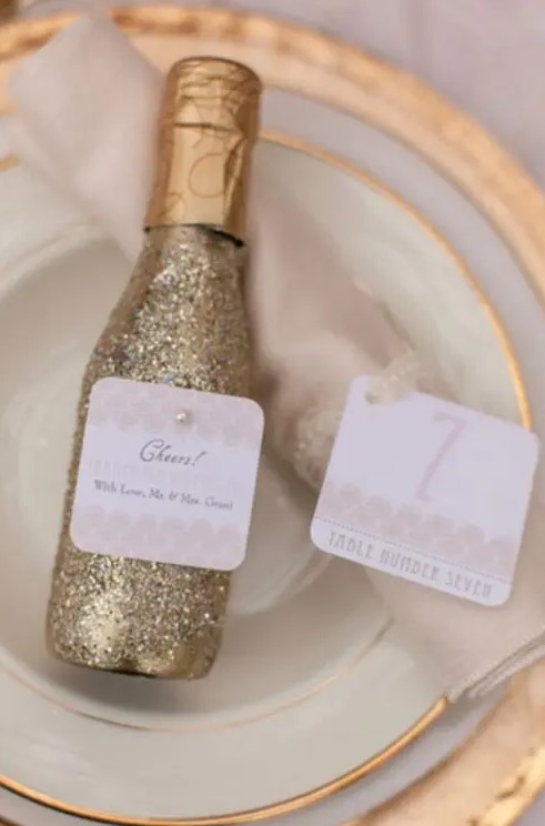 mini gold glitter champagne bottles are very cool Christmas, NYE or just winter wedding favors