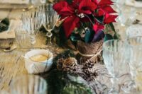 11 a beautiful Christmas wedding table setting with an evergreen and pinecone runner and potted poinsettias