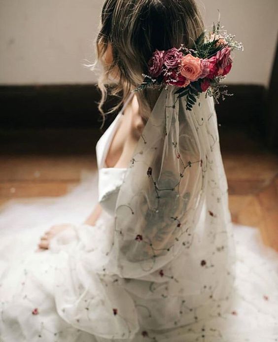 a floral embroidered veil and a fresh flower accent on top are a beautiful idea for a lovely boho bridal look