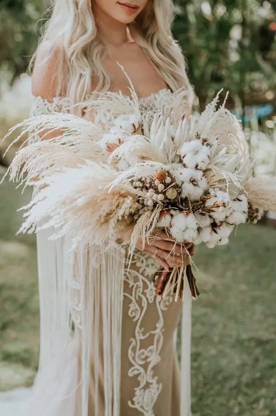 a beachy boho wedding bouquet of king proteas, cotton and pampas grass, with a burlap wrap is a lovely idea for summer or fall