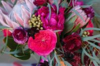 13 a bright and chic wedding bouquet with hot pink, fuchsia blooms, king proteas, greenery and grasses is great for the fall