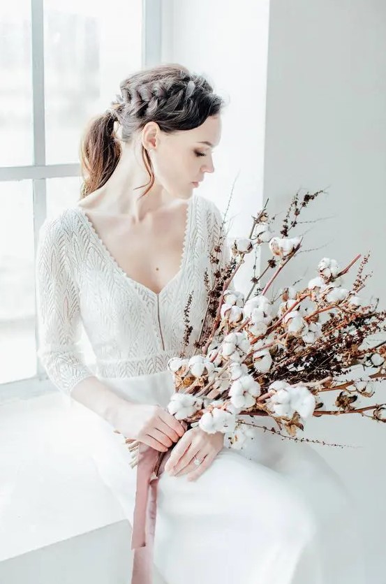 a delicate long stem wedding bouquet of cotton buds and dried flowers is a lovely idea for a delicate spring wedding
