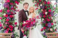 15 a bright wedding arch covered with greenery, hot pink, blush, violet and fuchsia blooms is a statement idea for a jewel tone wedding