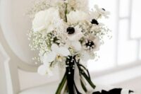 15 a chic black and white wedding bouquet of white orchids, roses and anemones, baby’s breath, some black and white ribbons