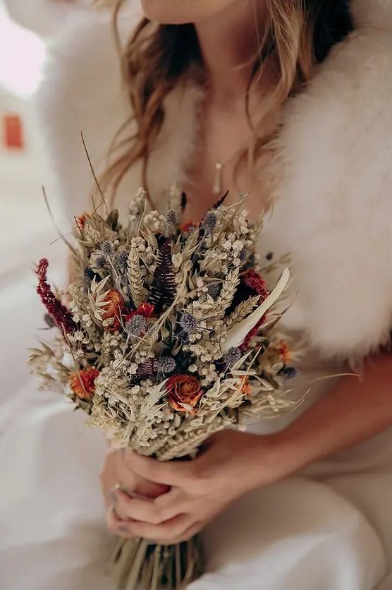 a dreamy rustic dried wedding bouquet with allium, roses, wheat, grasses, ferns, baby's breath and twigs is a great idea for the fall or summer