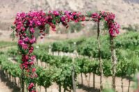 16 a bright wedding arch covered with magenta blooms and greenery will be a spectacular solution with plenty of color