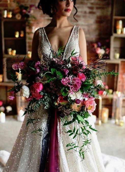 a colorful and lush winter wedding bouquet in pink, purple, withmuch greenery and texture for a colorful NYE wedding