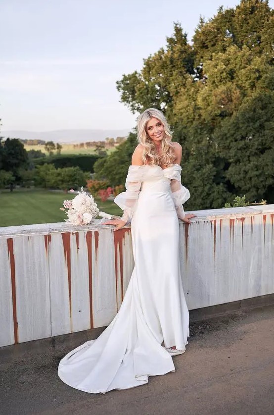 a modern romantic off the shoulder plain wedding dress with puff tulle sleeves and a train is a beautiful solution