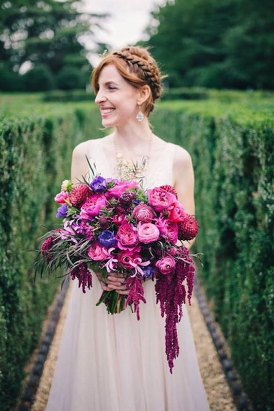 a bright wedding bouquet with hot pink, magenta and violet blooms plus some cascadin touches for a fall bride
