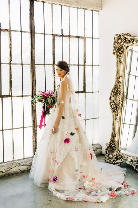 a cathedral veil accented with bold silk blooms is a gorgeous and colorful detail to finish off a bridal look