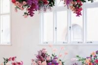 19 a bright wedding ceremony space with red, peachy, hot pink and fuchsia blooms and greenery is a very bold and catchy space