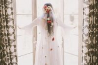 19 a cathedral veil with white and red fresh and dried blooms is a beautiful accent for a chic and lovely bridal look