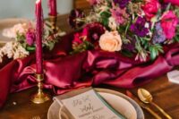 21 a chic wedding tablescape with a magenta runner and matching candles, bright blooms and greenery, neutral plates and a lilac napkin