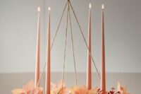 22 a Christmas wedding decoration, a chandelier covered with berries and poinsettias plus pink tall and thin candles