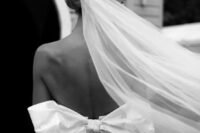 23 an adorable fitting wedding dress with an open back and a large bow plus a long veil for a dreamy and very romantic wedding look