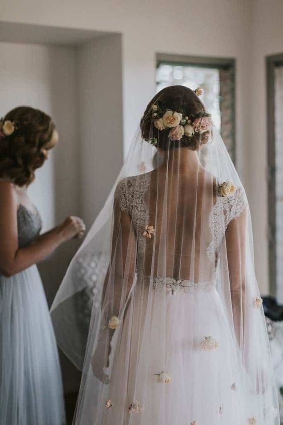 a gorgeous cathedral veil accented with fresh blush blooms is a fantastic idea for a flower-filled wedding