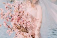 24 a jaw-dropping pink cherry blossom long stem wedding bouquet looks really heavenly and will match a spring bridal look