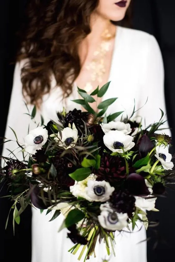 a moody bouquet with deep purple and white blooms and greenery is a lovely idea for a black and white NYE wedding