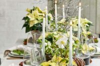 25 a lovely winter wedding tablescape with neutral linens, poinsettias, white blooms, evergreens, succulents and pinecones, tall and thin candles and evergreens