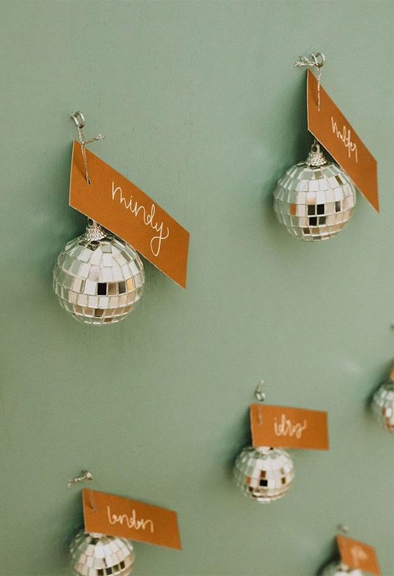 silver disco balls with tags are a great idea for a disco-themed or NYE wedding, they are easy to get and won't break the budget
