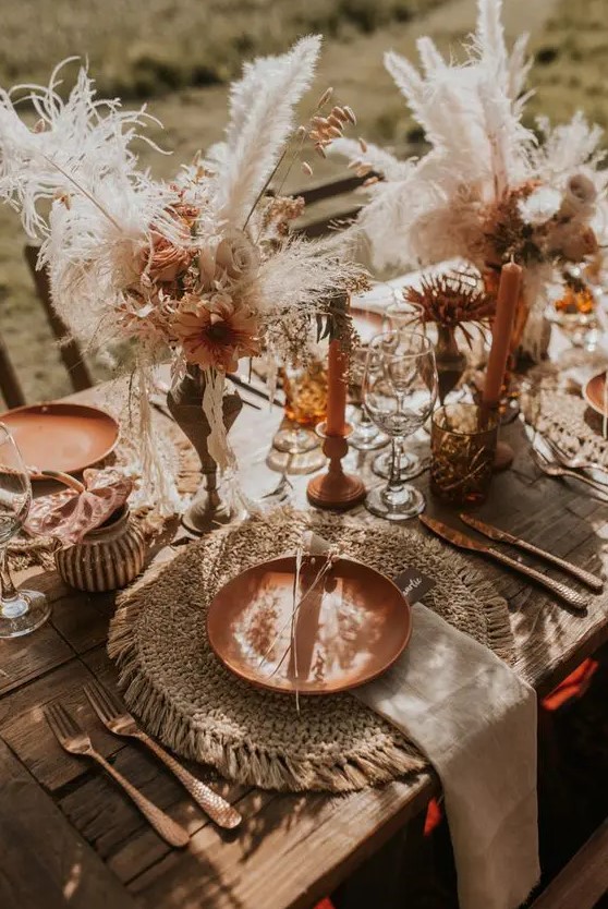 a beautiful Western fall wedding centerpiece of pretty rust-colored dried blooms, pampas grass and leaves is a lovely and rich-toned solution