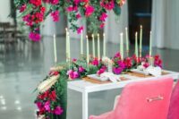 27 a gorgeous sweetheart table styling with red and fuchsia blooms over the table, with hot pink blooms on the table and pink chairs is amazing