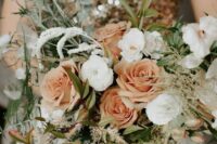 27 a soft-colored NYE wedding bouquet with peachy and white blooms and greenery plus some grasses is a lovely idea