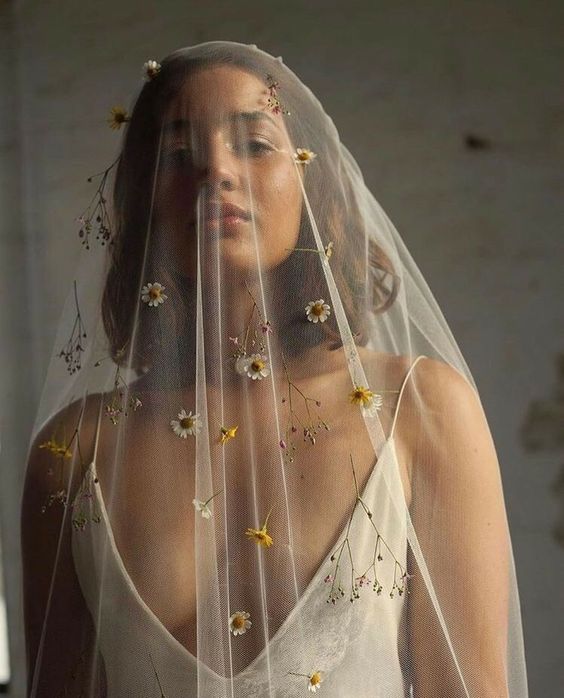 a super delicate and subtle veil accented with fresh white and yellow blooms and twigs is a beautiful idea for a boho bride