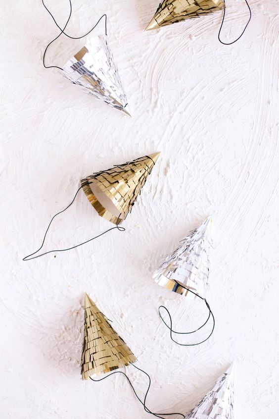 sparkling silver and gold cone hats are cute and fun as NYE wedding favors, they look great and are easy to make