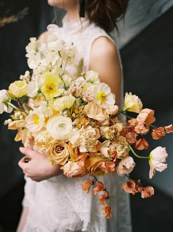 a beautiful ombre wedding bouquet from white to yellow, coffee-colored and dusty pink blooms including roses and poppies
