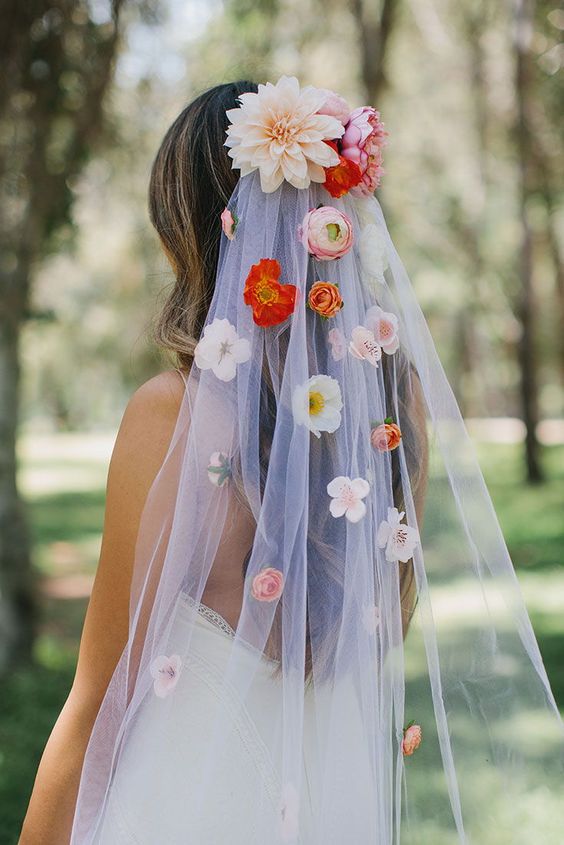 a wedding veil accented with silk and fresh blooms in neutrals, pink and coral is a gorgeous idea for a summer wedding