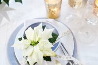 29 a winter holiday wedding place setting with a white poinsettia as a favor and an accent is a lovely idea for Christmas and not only