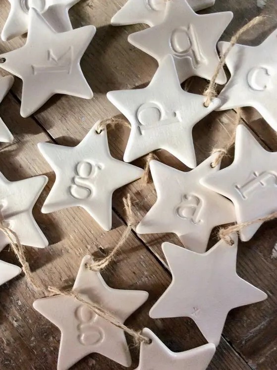 white clay star-shaped ornaments with monograms are amazing for Christmas and NYE weddings, make them yourself