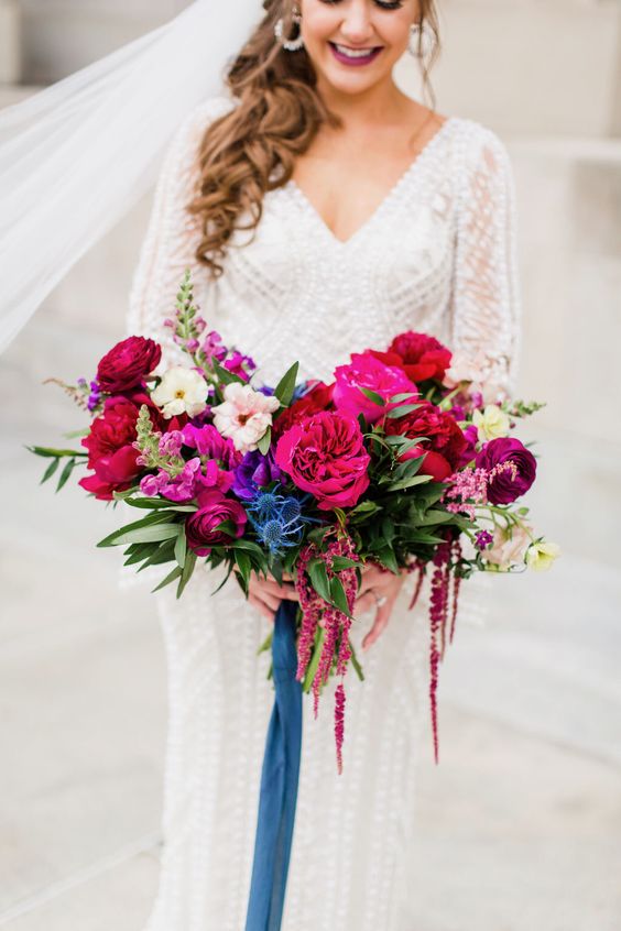 a jewel-tone wedding bouquet with hot pink, blush, magenta and violet blooms, thistles and greenery is a lovely idea