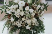 30 a super lush white wedding bouquet of blooms, greenery, fern, pinecones and long emerald ribbons is amazing for winter and can be rocked in the fall