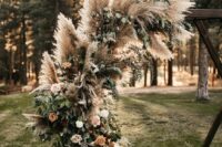 31 a round wedding arch decorated with pampas grass, roses of various shades and greenery is great for a Western boho wedding