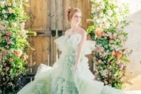 31 a unique pastel green tiered ruffle A-line wedding dress with a train and on spaghetti straps for more comfort is a unique idea