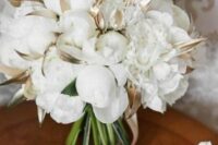 31 a white peony wedding bouquet with gilded leaves and ribbon is a lovely and pretty idea for a NYE wedding