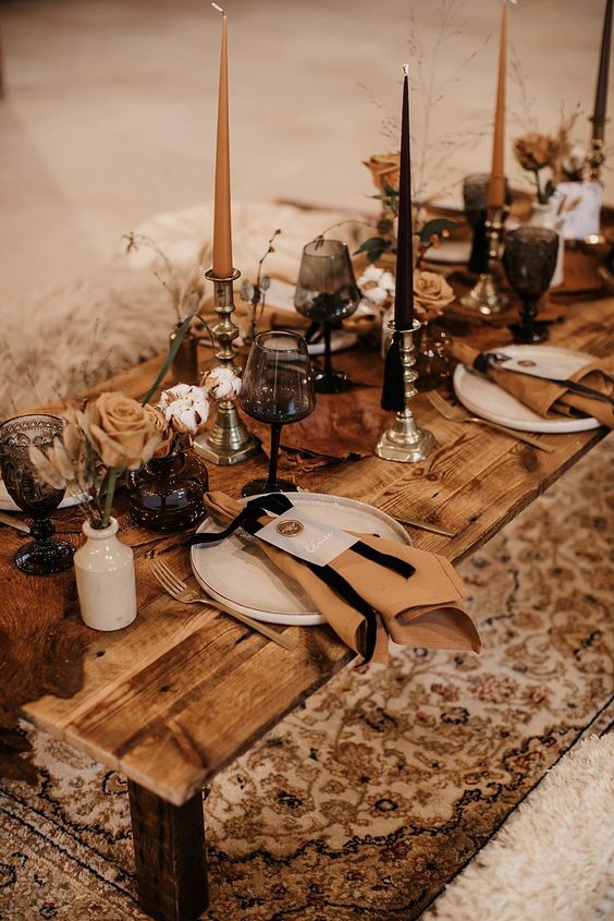 a beautiful Western wedding tablescape with pampas grass, rust roses, rust and black candles and white porcelain