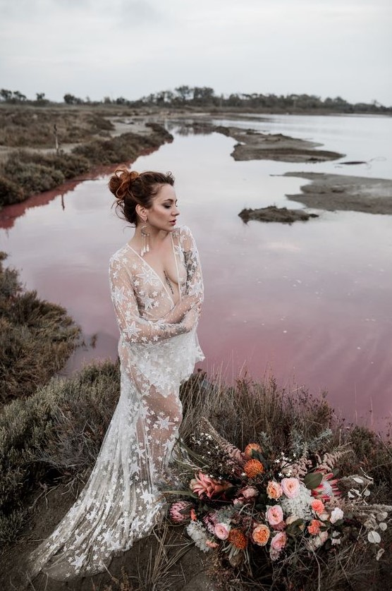 a celestial white sheer wedding dress with long sleeves and a train can be worn with some underwear or a bodysuit under