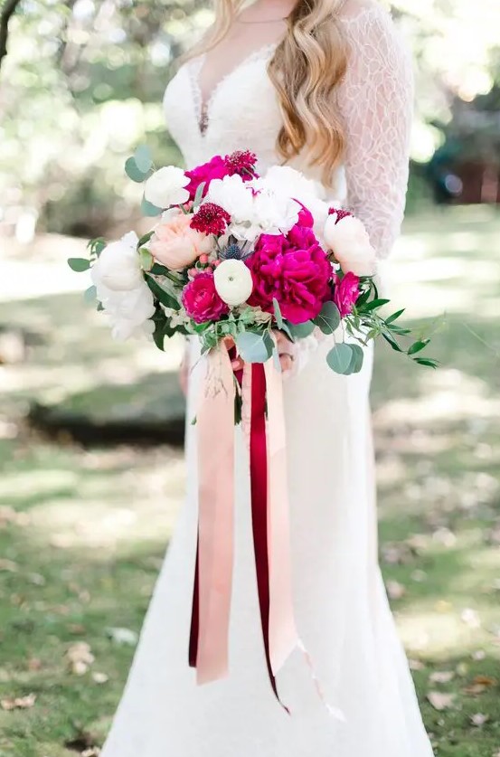 a lovely wedding bouquet of fuchsia peonies, white and blush ones, with long burgundy and blush ribbons is amazing
