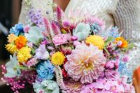 32 a vibrant wedding bouquet that includes pink, blue, yellow and hot pink blooms and a bold wrap plus ribbons