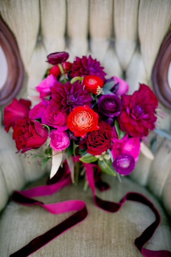 a jewel-tone wedding bouquet with hot pink, red, purple and magenta blooms and greenery is a stunning idea for the fall