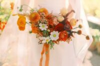34 a beautiful fall wedding bouquet with orange dahlias, deep red and burgundy blooms, some blooming twigs and orange ribbon