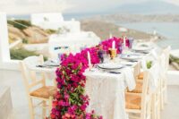 34 a lovely wedding tablescape with a view and a gorgeous red and magenta bloom table runner is fantastic