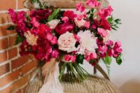 37 a bold fuchsia and blush wedding bouquet with much dimension and texture and blush ribbons for a Valentine wedding