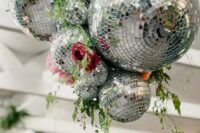 37 a bold wedding decoration of disco balls, bright blooms and greenery is a stylish and cool idea to rock